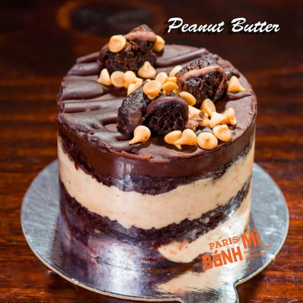 Peanut Butter cake from Paris Bánh Mì, with chocolate layers, peanut butter frosting, and toppings.
